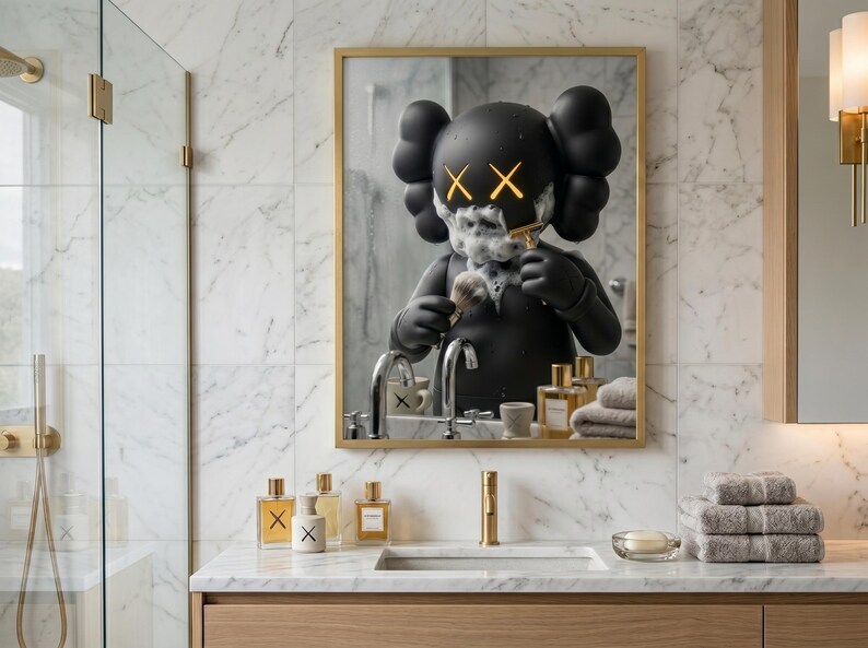 May include: A rectangular wall mirror with a gold frame reflecting a black cartoon character with X-shaped eyes covered in shaving foam. The character holds a shaving brush and razor. The bathroom vanity below features glass perfume bottles and towels.