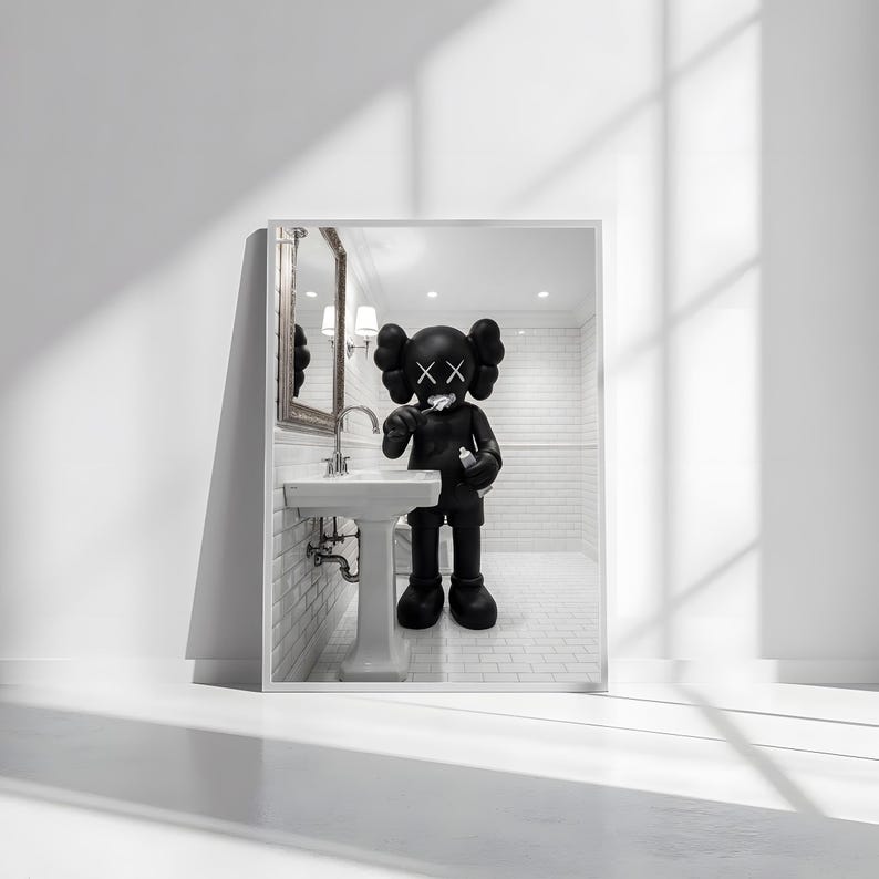 May include: A framed print featuring a black and white illustration of a cartoon figure brushing its teeth in a bathroom setting. The figure has large, round ears and X-shaped eyes. The bathroom includes a sink, mirror, and tiled walls.