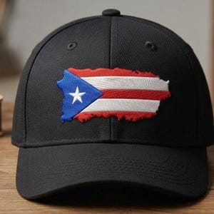May include: Black baseball cap with an embroidered Puerto Rican flag. The flag design features a blue triangle with a white star, and red and white stripes. The cap has a curved peak and a button on top.