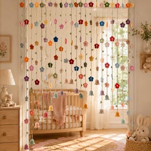 May include: A decorative doorway curtain featuring multiple vertical strands of crocheted flowers and bell-shaped blossoms in various colors including red, blue, yellow, orange, pink, and purple, suspended from a horizontal rod across a doorway.