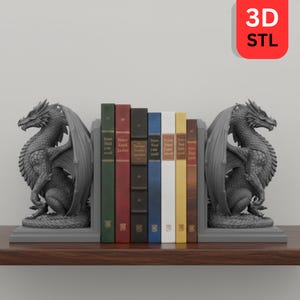 May include: Gray dragon bookends flanking a row of colorful books. The dragon bookends are detailed with wings and scales. The books have various colored spines, including green, red, and blue. The image includes a 3D STL logo.