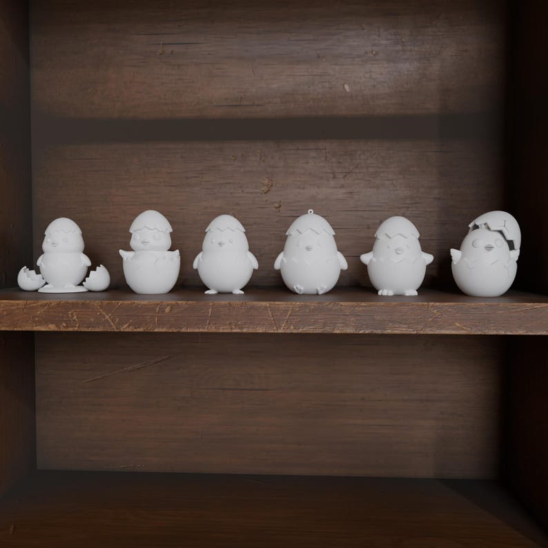 May include: A collection of seven white ceramic Easter chick figurines in various stages of hatching, displayed on a dark wooden shelf. The chicks are in different poses, some emerging from cracked eggs, others standing upright.