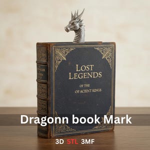 May include: A silver dragon bookmark is inserted into a vintage book titled "Lost Legends of the ACIENT KINGS." The book has a dark blue cover with gold lettering and ornate designs. The text "Dragonn book Mark" is at the bottom.