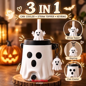 May include: A 3-in-1 ghost-themed set featuring a white can cooler with a black lid and ghost face, a white ghost straw topper, and a white ghost keyring. The text 3 IN 1, CAN COOLER, STRAW TOPPER, KEYRING, and GHOST DRINKS are printed on the items.