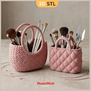 May include: Two pink decorative containers, one woven and one quilted, each holding makeup brushes and tools. The woven container has a handle, while the quilted one has a structured handbag design. The image includes the text "3D STL" and "MasterMesh STUDIO."