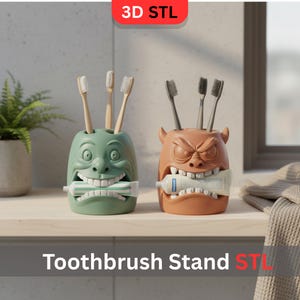 Puede incluir: Dos originales porta cepillos de dientes, uno verde y otro naranja, cada uno con forma de cara con una boca ancha que sostiene un tubo de pasta de dientes. El soporte verde tiene una cara amigable, mientras que el naranja tiene una expresión más enojada. El texto "Toothbrush Stand STL" está en la parte inferior.
