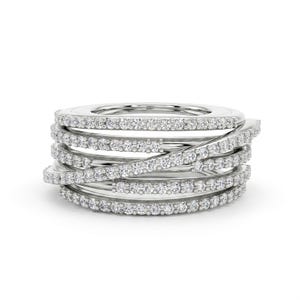 May include: A silver ring with multiple bands, each encrusted with small, clear gemstones. The bands are interwoven, creating a layered and textured appearance. The ring has a modern and elegant design.