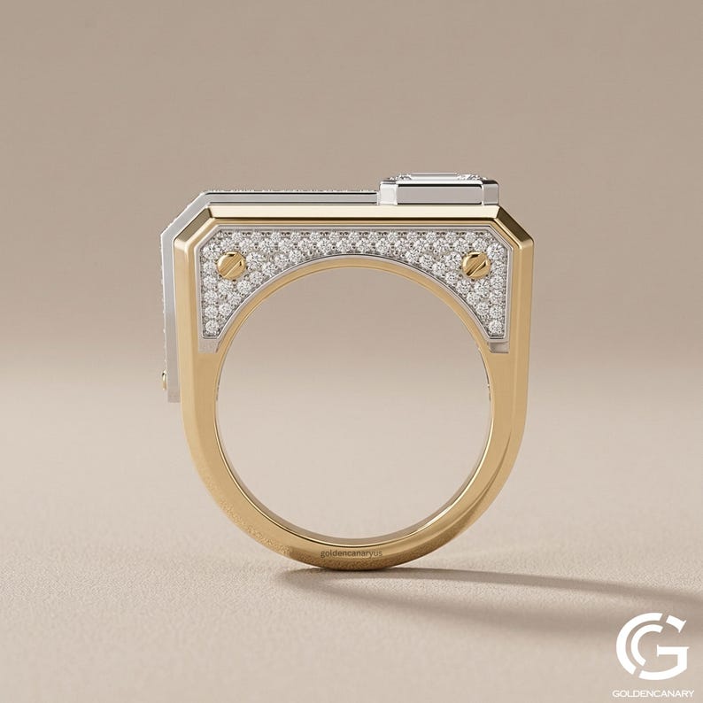 Side profile view of an architectural, two-tone gold ring standing upright. The flat-top design showcases a white gold side plate encrusted with pave diamonds and secured by two yellow gold screws, with a raised emerald-cut diamond visible on top.