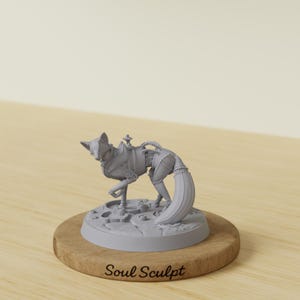May include: A light gray, unpainted miniature figurine of a fox with mechanical, gear-like details on its body, standing on a circular base. The base is mounted on a round wooden plaque with the text Soul Sculpt engraved on the front surface.