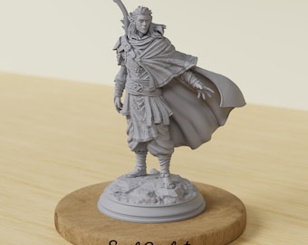 May include: A gray figurine of a character in a flowing cape, holding a bow, standing on a rocky base atop a wooden disc. The figurine has detailed clothing and a determined expression. The text "Soul Sculpt" is at the base.