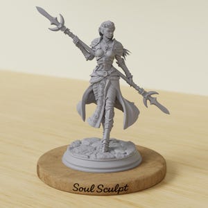 May include: A gray figurine of a female warrior holding two spears. The figure is detailed with armor and flowing fabric, standing on a textured base. The base is set on a round wooden stand. The text "Soul Sculpt" is at the bottom.
