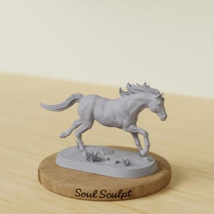 May include: A gray sculpture of a running horse with flowing mane and tail, mounted on a gray base with grass and rocks. The base sits on a round wooden stand. The text "Soul Sculpt" is printed on the wooden stand.