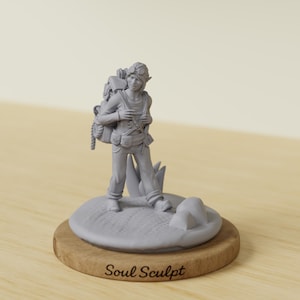 May include: A gray figurine of a person with a backpack, goggles, and elf-like ears, standing on a small, round base. The base is made of wood and has the text "Soul Sculpt" engraved on it. The figurine is set against a neutral background.