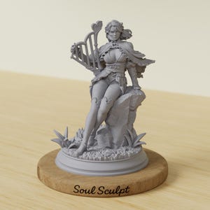 May include: A grey sculpture of a woman seated on a rock, holding a harp with a heart-shaped top. The sculpture is on a wooden base with the text "Soul Sculpt". The woman is wearing a detailed outfit with a cape.