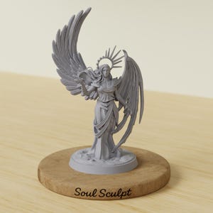 May include: A grey angel figurine with detailed wings and a halo, standing on a round wooden base. The text "Soul Sculpt" is printed on the base. The figurine is a sculpture.