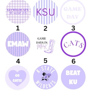May include: A collection of nine circular purple and white stickers featuring various designs including a gingham pattern, vertical stripes, a cowboy boot, a mascot, and text such as GO WILDCATS, KSU, GAME DAY, EMAW, GAME DAYS IN MHK, CATS, GO CATS!, K-STATE WILDCATS, and BEAT KU.