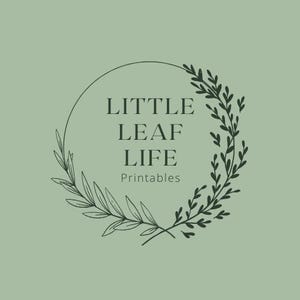 May include: A logo design featuring the text "LITTLE LEAF LIFE Printables" in a serif font, encircled by a dark green botanical wreath on a light green background. The wreath is composed of delicate leaves and branches.