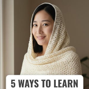 May include: A woman wearing a cream-colored crocheted shawl and hood. The shawl is draped over the shoulders and head, with a textured, open weave design. The text "5 WAYS TO LEARN" is displayed on a white rectangular banner.