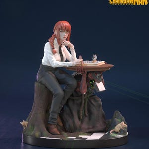 May include: A detailed figurine of a woman with red hair, wearing a white shirt and black pants, seated on a tree stump. She is playing chess on a small table supported by a monster. The figurine has a dark base with the text "CHAINSAW MAN".