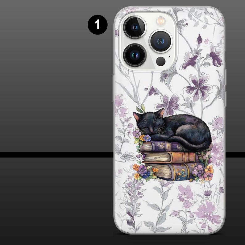May include: A phone case featuring a sleeping black cat atop a stack of books. The case has a white background with a floral pattern in shades of purple and gray. The books are adorned with flowers.