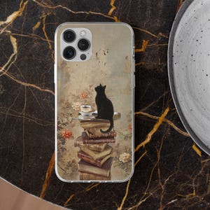 May include: Clear phone case featuring a vintage-style design with a black cat perched atop a stack of books. A small table holds a teacup and saucer. The background has a floral and aged wall design.