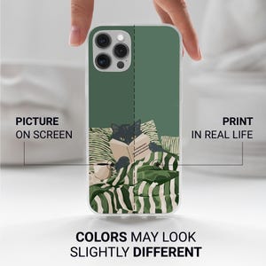 May include: A phone case featuring a black cat reading a book while lying in bed. The design includes green and white striped bedding and pillows. The text on the case reads "Picture on Screen" and "Print in Real Life."