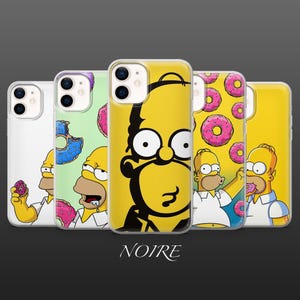 May include: A selection of phone cases with cartoon character Homer Simpson designs. The cases showcase Homer's face, donuts, and other imagery. The cases are in yellow, white, and green.