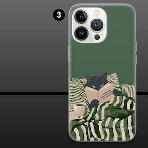 May include: A phone case with a green background featuring a black cat reading a book with the text "COMMENT DOMESTIQUER LES HUMAINS". The cat is under a green and white striped blanket, with a coffee cup on the side.