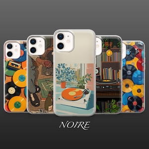 May include: A collection of phone cases featuring vintage-inspired illustrations. Designs include a record player, a person holding a wine glass, and stacks of vinyl records. The word "NOIRE" is at the bottom.