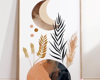May include: Abstract art print with a crescent moon in brown and beige tones, and botanical elements in gold, black, and tan. The artwork includes an earthy-toned base and is framed in light wood. The print is a modern piece.