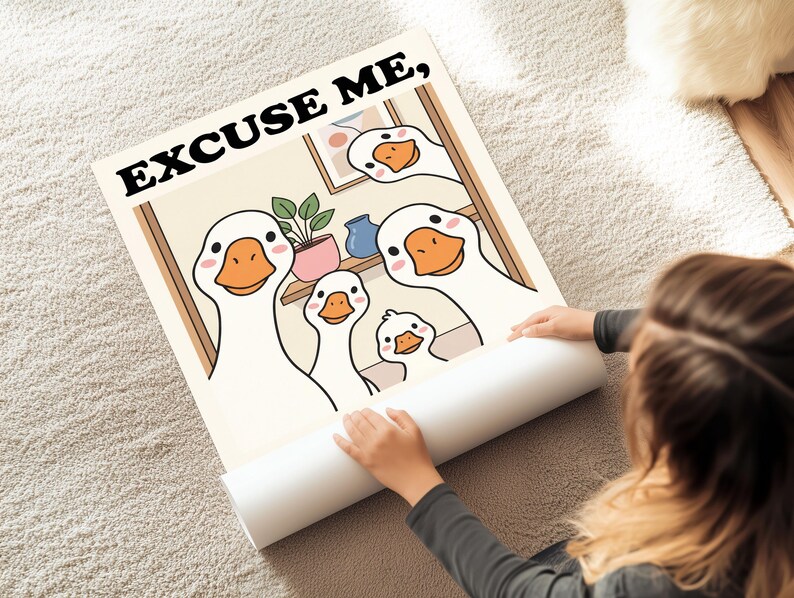 May include: A rolled-up poster featuring a cartoon illustration of a family of geese. The geese have white feathers, orange beaks, and pink cheeks. The poster has the text "EXCUSE ME," in black letters at the top.