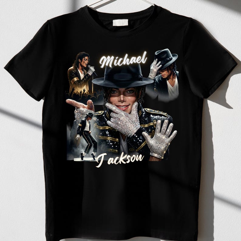 May include: Black t-shirt featuring a collage of images of Michael Jackson. The design includes the name "Michael Jackson" in white script. The images show Jackson in various poses, including wearing a hat and gloves.