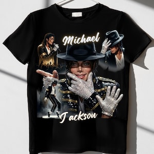 May include: Black t-shirt with multiple images of Michael Jackson. The central image shows him wearing a hat and jeweled gloves. The name "Michael Jackson" is written in white script across the top and "Jackson" at the bottom.