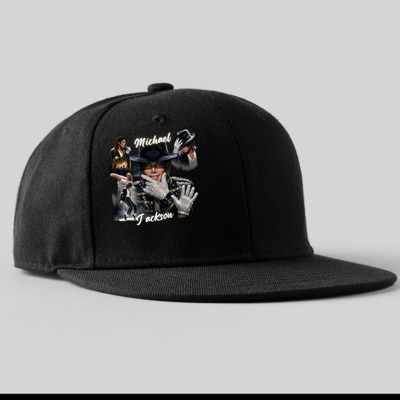 May include: Black snapback hat featuring a graphic of Michael Jackson. The graphic includes images of Jackson and his name. The hat has a flat brim and a structured crown, suitable for casual wear.