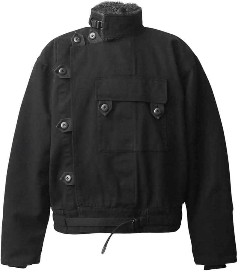 May include: A black jacket featuring a high collar with a faux fur lining, an asymmetrical front closure secured by multiple buttoned tabs, a single chest pocket with a buttoned flap, and an adjustable strap at the hemline for a fitted look.
