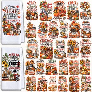 May include: A collection of white rectangular kitchen towels featuring various autumn-themed graphic prints including pumpkins, sunflowers, fall foliage, and inspirational text such as Every Leaf Speaks Bliss to Me and I Can Do All Things Through Christ.