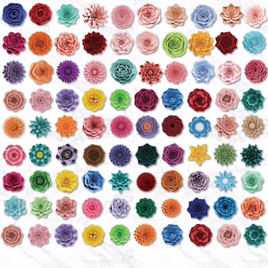 May include: A collection of colorful, paper-crafted flowers in various shapes and sizes. The flowers are arranged on a white marble-patterned surface. Colors include shades of red, pink, orange, yellow, blue, green, and purple. The flowers are likely for crafting or decoration.