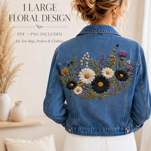 May include: A blue denim jacket featuring a large, colourful floral embroidery design on the back. The text 1 LARGE FLORAL DESIGN PDF + PNG INCLUDED For Tote Bags, Pockets & Clothing is visible. The embroidery includes white, black, and yellow flowers.