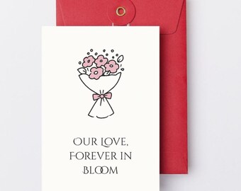 May include: A white greeting card with a black line drawing of a flower bouquet with pink flowers and a pink bow. The card is paired with a red envelope. The text on the card reads "OUR LOVE, FOREVER IN BLOOM."