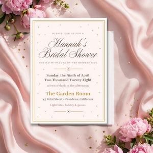 Pode incluir: Um cartão de convite retangular para o chá de panela de Hannah com bordas douradas e detalhes de estrelas douradas. O texto inclui a data domingo, 9 de abril de 2028, The Garden Room e 45 Petal Street, Pasadena, Califórnia.