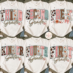 May include: Six white t-shirts featuring graphic prints for school grades including Third Grade, Second Grade, Pre-K, Kindergarten, Fourth Grade, and First Grade. The designs use a mix of leopard print, pink plaid, and floral patterns with stars.