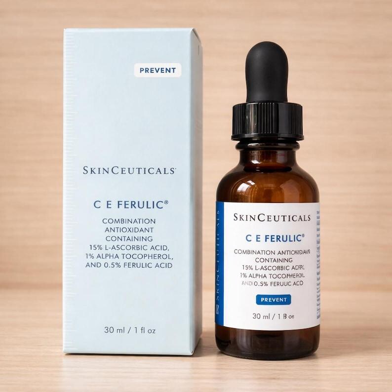May include: A SkinCeuticals C E Ferulic serum bottle with a black dropper cap and its light blue cardboard box. The packaging displays the text: Combination Antioxidant containing 15% L-Ascorbic Acid, 1% Alpha Tocopherol, and 0.5% Ferulic Acid, 30 ml / 1 fl oz.
