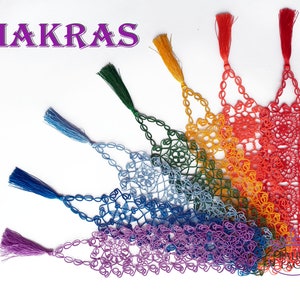 May include: A set of seven crocheted bookmarks in rainbow colours, each with a tassel. The bookmarks are arranged in a fan shape, with the purple bookmark at the bottom and the red bookmark at the top. The bookmarks are labelled "CHAKRAS".