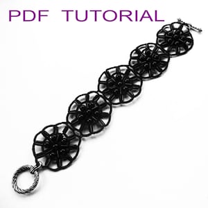 May include: Black beaded bracelet with a circular design. The bracelet has a clasp and a ring closure.