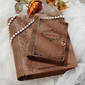 May include: Two rectangular wooden boxes with hinged lids, featuring laser-engraved floral patterns and text. The smaller box displays the names Allison & Aaron, while the larger box includes the text Make Space for Your Precious Moments.
