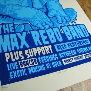 May include: A blue and white poster for "The Max Rebo Band" with the text "Plus Support" and "Also Featuring: Live Rancor Feedings Between Shows and Exotic Dancing by Oola". The poster also includes the text "Bounty Hunters Welcome!"