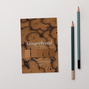 May include: A color palette card with a gingerbread theme, featuring various shades of brown. The card includes the word "Gingerbread" and the text "COLOR PALETTE". Two pencils, one teal and one dark green, are positioned to the right of the card.