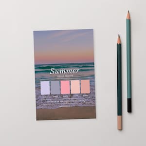 May include: A card featuring a summer colour palette with a beach scene. The card displays six colour swatches in shades of lavender, grey, pink, peach, and coral. Two pencils are positioned to the right of the card.