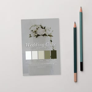 May include: A wedding cake colour palette card with a floral design and the words "Wedding Cake Color Palette". Two pencils, one teal and one dark green, are positioned to the right of the card.