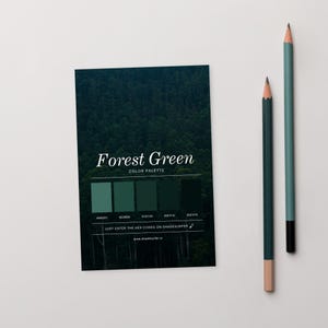 May include: A card displaying a "Forest Green" colour palette, featuring a forest image and five green swatches. Two pencils, one dark green and one teal, are placed to the right of the card.